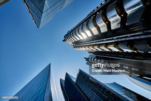 low angle view looking directly up at glass and steel office building in the city of london england uk. - looking up at buildings stock pictures, royalty-free photos & images