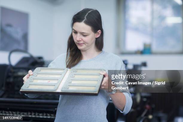 print worker examining printing plate in an industry, freiburg im breisgau, baden-wurttemberg, germany - printer frustration stock pictures, royalty-free photos & images