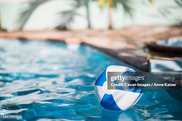 inflatable ball drifting in swimming pool - ゴムボール ストックフォトと画像