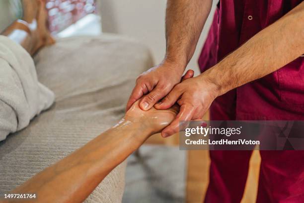 woman receiving a hand massage - hand massage stock pictures, royalty-free photos & images