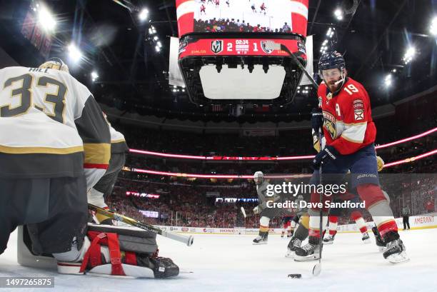 Matthew Tkachuk of the Florida Panthers maneuvers the puck in front of goaltender Adin Hill of the Vegas Golden Knights before scoring the game tying...