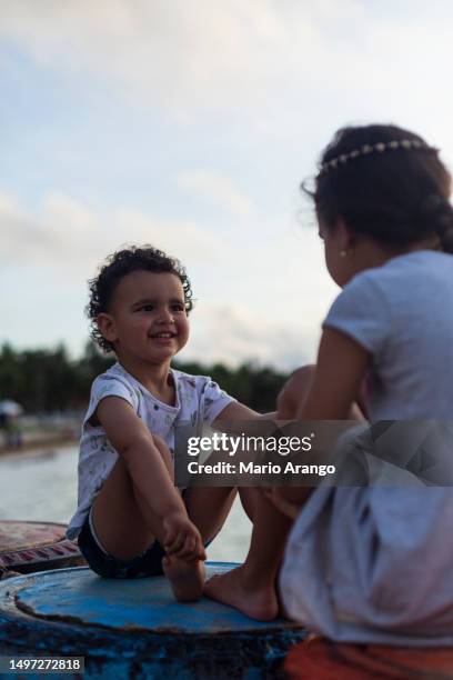 little brothers enjoy a beautiful sunrise on san andres island - mario bros stock pictures, royalty-free photos & images