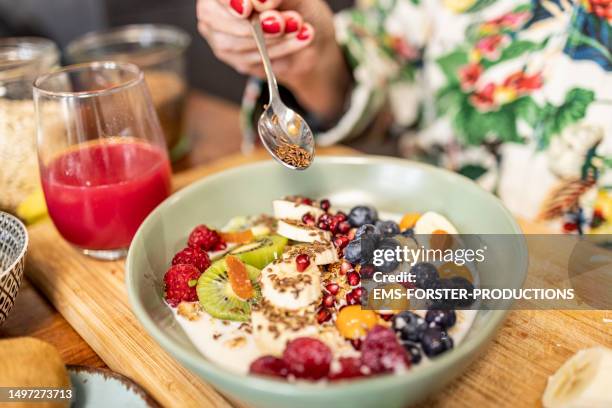 close up of healthy breakfast - superfood bowl with yogurt and fruits - flax seed stock pictures, royalty-free photos & images