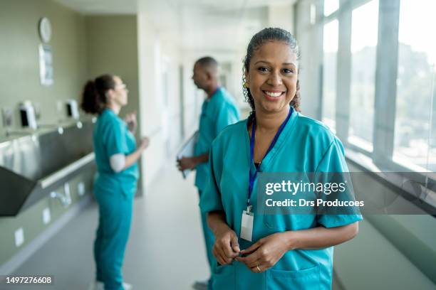 nurse portrait at hospital clinic - female nurse stockfoto's en -beelden