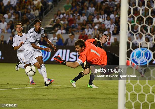 Iker Casillas of Real Madrid as the ball bounces away after he made save with his left hand against Robbie Keane of Los Angeles Galaxy during the...