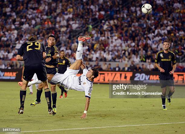 Cristiano Ronaldo of Real Madrid attempts a bicycle kick against Rafael Garcia and Andrew Boyens of Los Angeles Galaxy during the World Football...
