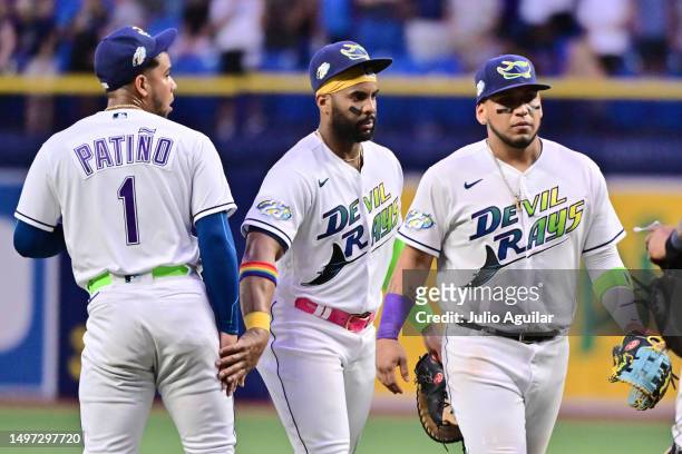 Luis Patino celebrates with Yandy Diaz and Isaac Paredes of the Tampa Bay Rays after defeating the Texas Rangers 8-3 at Tropicana Field on June 09,...