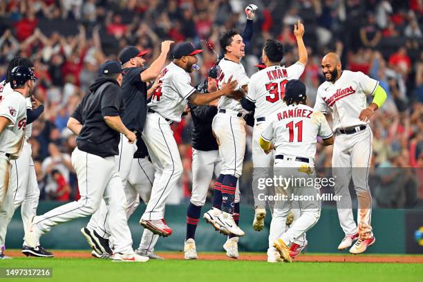 Will Brennan of the Cleveland Guardians celebrates with teammates after hitting a walk-off RBI double during the fourteenth inning to defeat the...