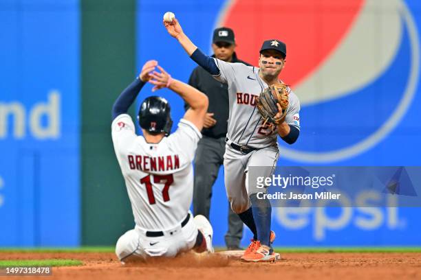 Second baseman Jose Altuve of the Houston Astros forces out Will Brennan as he throws out David Fry of the Cleveland Guardians at first to end the...