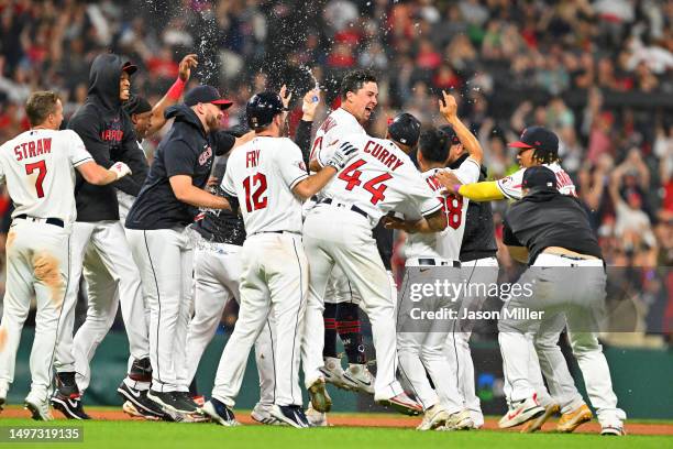 Will Brennan of the Cleveland Guardians celebrates with teammates after hitting a walk-off RBI double during the fourteenth inning to defeat the...