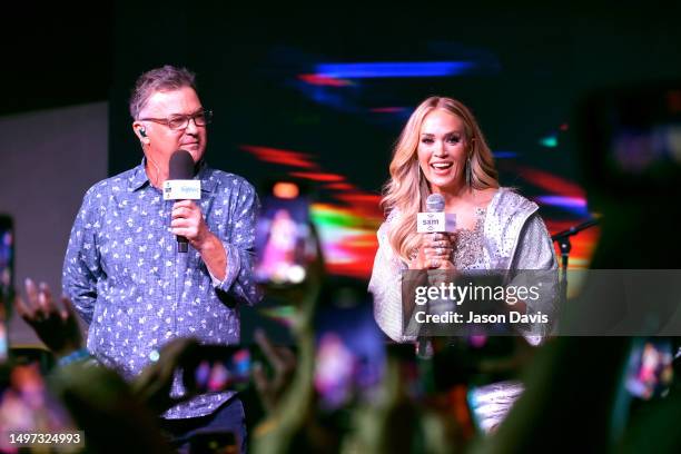 Cam "Buzz" Brainard and Carrie Underwood speak onstage during the launch of the Exclusive SiriusXM Channel CARRIE'S COUNTRY Live from Margaritaville...
