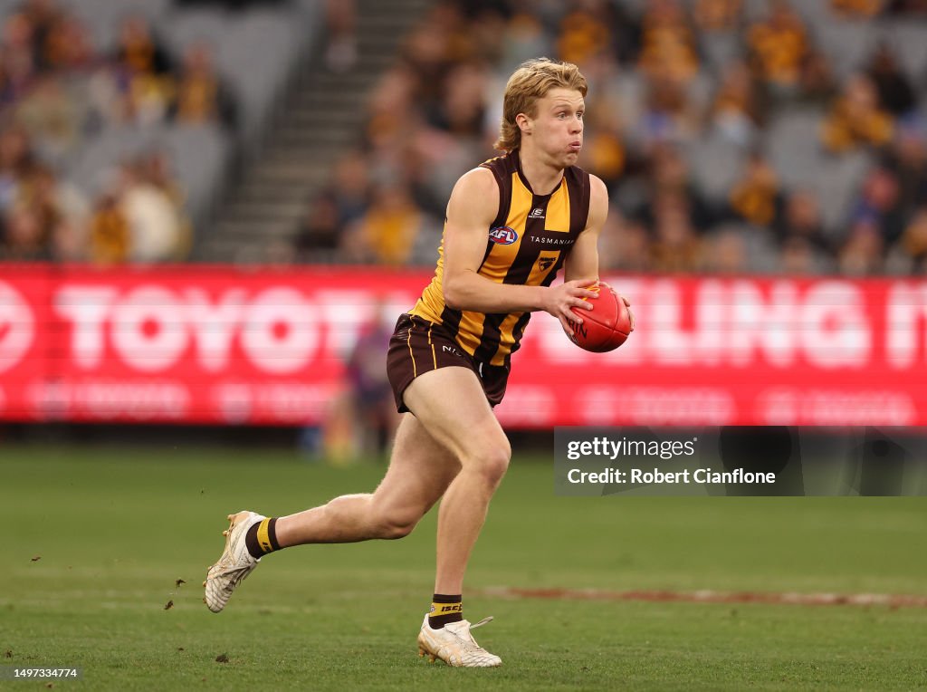 Kyle Hardingham Kyle Hartigan of the Hawks runs with the ball during the round 13 AFL ...
