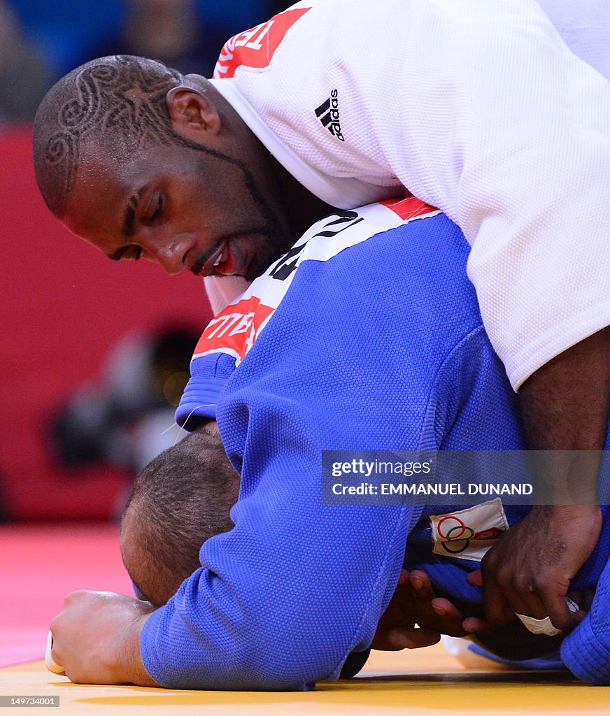 France's Teddy Riner (white) competes wi