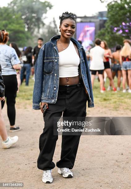 Moesha is seen wearing a Tommy Hilfiger jean jacket, cream top, black pants and New Balance sneakers during Governors Ball Music Festival 2023 at...