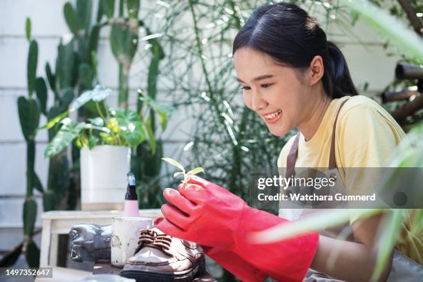 beautiful asian woman recycled old shoes in garden - plastic flower pot stock pictures, royalty-free photos & images