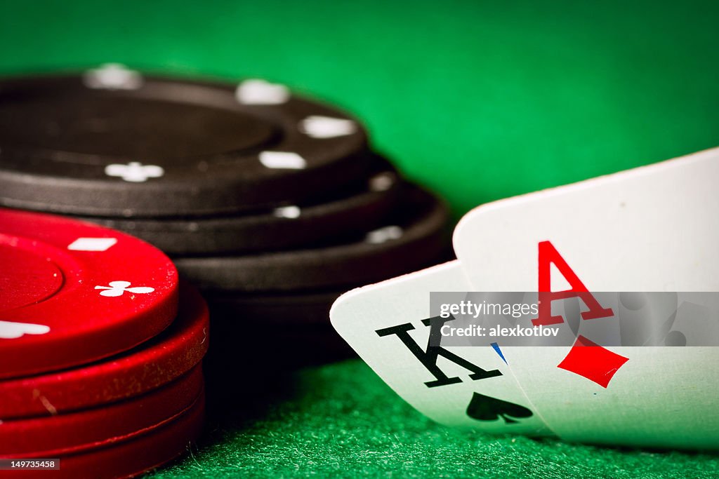 Poker table with poker chips and an ace and a king cards