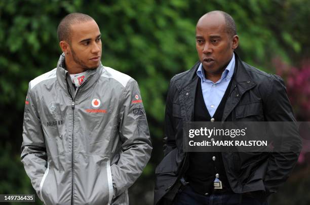 McLaren-Mercedes driver Lewis Hamilton of Britain and his father Anthony Hamilton arrive for the first practice session of Formula One's Chinese...