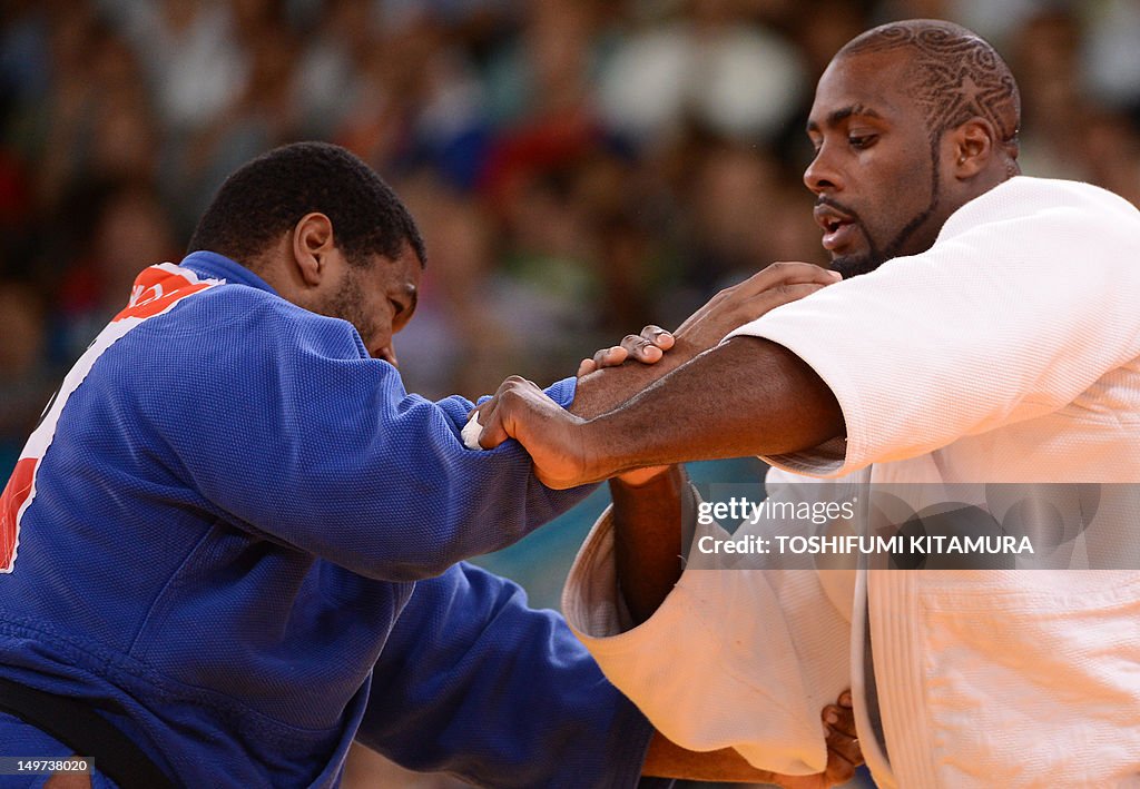 France's Teddy Riner (white) competes wi