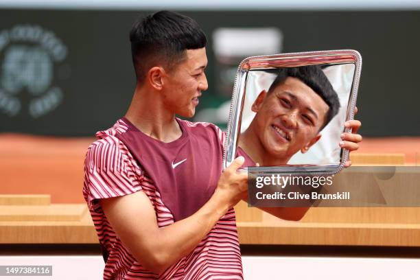 Tokito Oda of Japan celebrates with the trophy after victory against Alfie Hewett of Great Britain in the Men's Wheelchair Singles Final on Day...