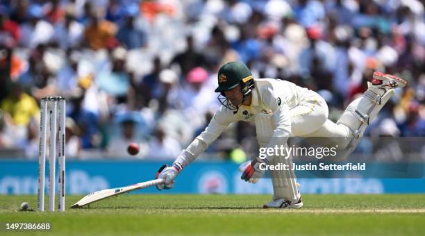 Alex Carey of Australia dives to make their ground during day four of the ICC World Test Championship Final between Australia and India at The Oval...
