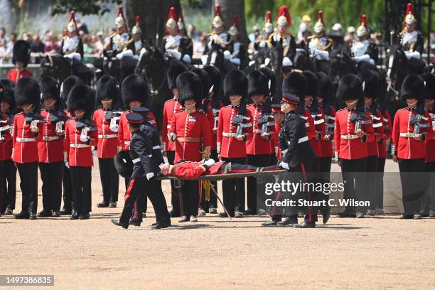 Welsh Guardsman is stretchered away while Prince William, Prince of Wales Carries Out The Colonel's Review at Horse Guards Parade on June 10, 2023 in...