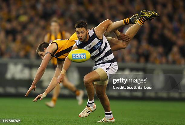 Jimmy Bartel of the Cats and Ben Stratton of the Hawks compete for the ball during the round 19 AFL match between the Hawthorn Hawks and the Geelong...