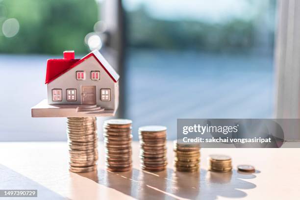 home concept, home savings, selling home, money and house, business and finance concept money and house - property prices continue to increase stock-fotos und bilder