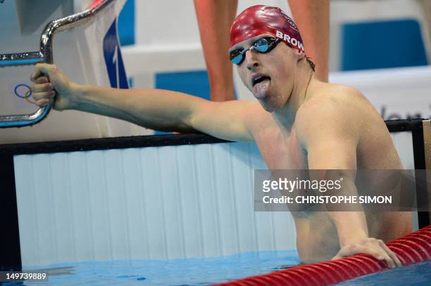 Britain's Adam Brown sticks his tongue out after he competed in the men's 4x100m medley relay heats during the swimming event at the London 2012...
