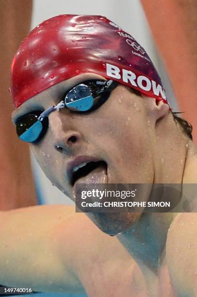 Britain's Adam Brown sticks his tongue out after he competed in the men's 4x100m medley relay heats during the swimming event at the London 2012...