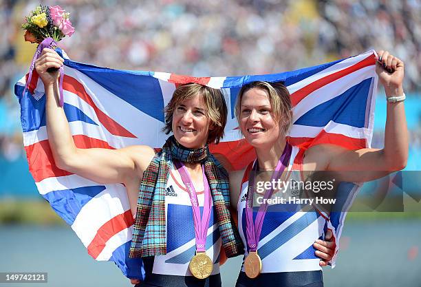 Katherine Grainger and Anna Watkins of Great Britain celebrate with their gold medals draped in a Union Jack during the medal ceremony for the...