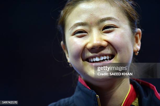 Japan's Ai Fukuhara smiles after her match against Ariel Hsing of the US in a women's team table tennis match at The Excel Centre in London on August...