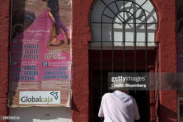 Man waits to purchase tickets for a bullfighting event at a kiosk outside the bullring in Ciudad Real, Spain, on Thursday, Aug. 2, 2012. The European...