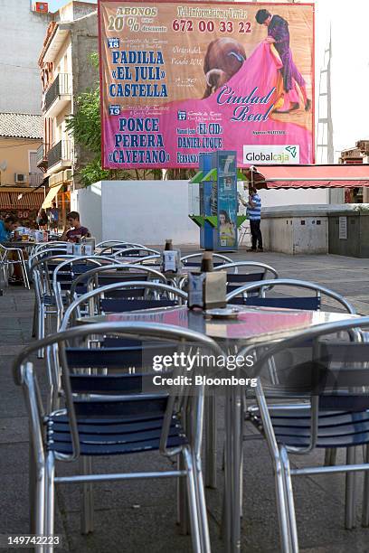 Poster advertising an upcoming bullfight hangs on a wall beyond an empty restaurant on Plaza Mayor in Ciudad Real, Spain, on Thursday, Aug. 2, 2012....