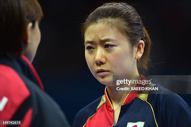 Japan's Ai Fukuhara listens to a coach during a break in her women's team table tennis match against Ariel Hsing of the US at The Excel Centre in...