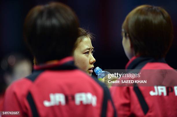 Japan's Ai Fukuhara drinks during a break in her women's team table tennis match against Ariel Hsing of the US at The Excel Centre in London on...