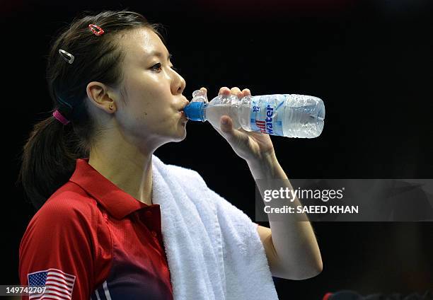 Ariel Hsing of the US drinks during a break in her womens's team table tennis match against Japan's Ai Fukuhara at The Excel Centre in London on...