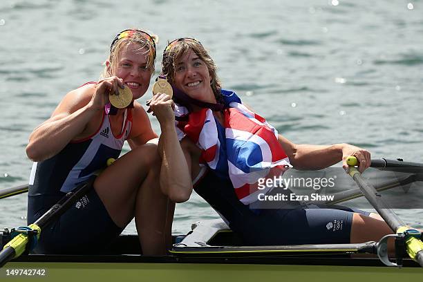 Anna Watkins and Katherine Grainger of Great Britain celebrate in their boat with their gold medals during the medal ceremony for the Women's Double...