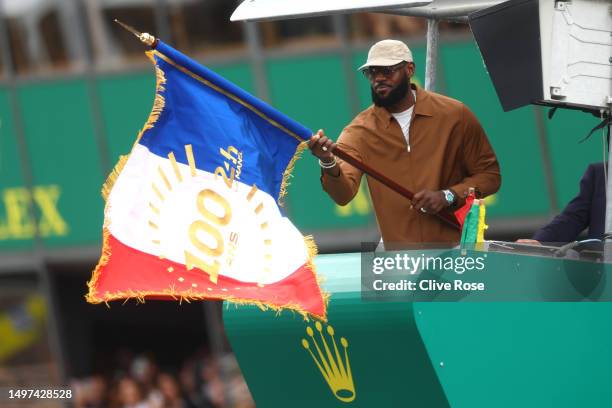 Honorary race starter, LeBron James of the United States waves the flag to start the 100th anniversary of the 24 Hours of Le Mans at the Circuit de...