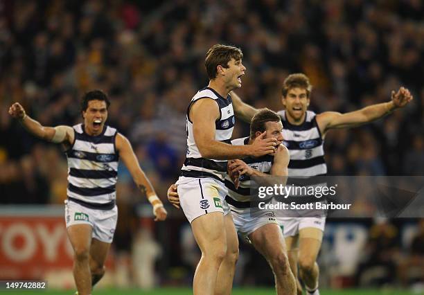 Tom Hawkins of the Cats watches as his kick goes for a goal to win the match during the round 19 AFL match between the Hawthorn Hawks and the Geelong...