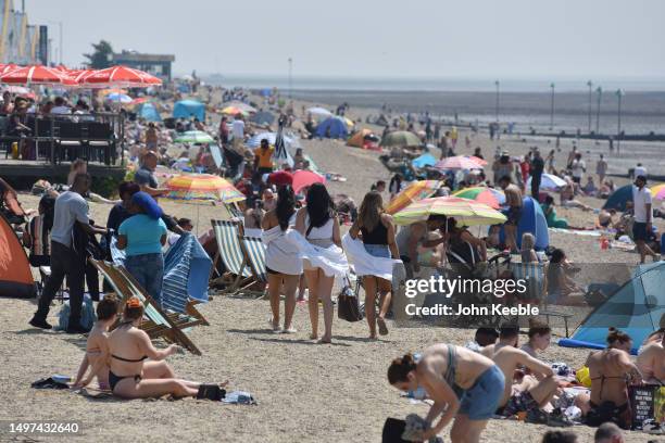 Crowds of people gather to enjoy the warm sunny weather on Jubilee beach on June 10, 2023 in Southend, England. Heat health warnings have been issued...