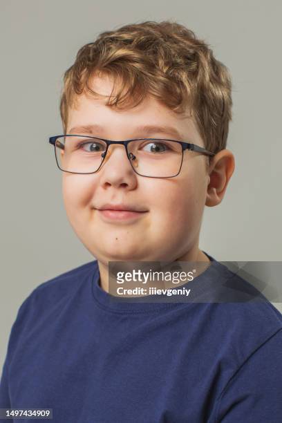 blonde boy in glasses and jeans with suspenders in studio on white background. child. childhood. schoolboy - head forward white background imagens e fotografias de stock