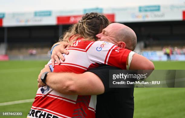 Sean Lynn, Head Coach of Gloucester-Hartpury embraces Sarah Beckett of Gloucester-Hartpury following the Allianz Premier 15s Semi Final match between...