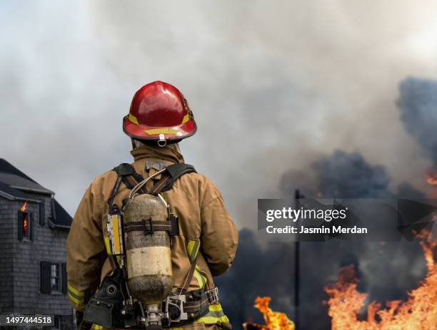 fireman in action - firefighter stock pictures, royalty-free photos & images