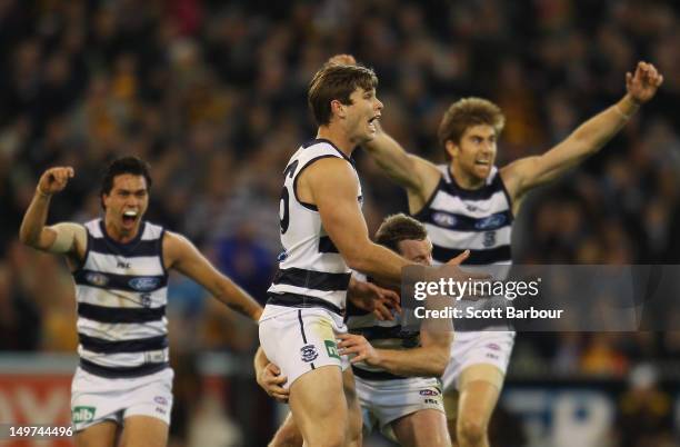 Tom Hawkins of the Cats watches as his kick goes for a goal to win the match during the round 19 AFL match between the Hawthorn Hawks and the Geelong...