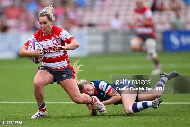 Natasha Hunt of Gloucester-Hartpury is tackled by Lucy Burgess of Bristol Bears during the Allianz Premier 15s Semi Final match between...