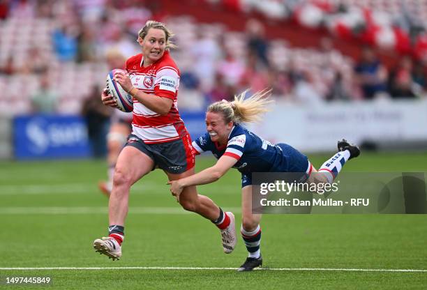 Natasha Hunt of Gloucester-Hartpury is tackled by Lucy Burgess of Bristol Bears during the Allianz Premier 15s Semi Final match between...