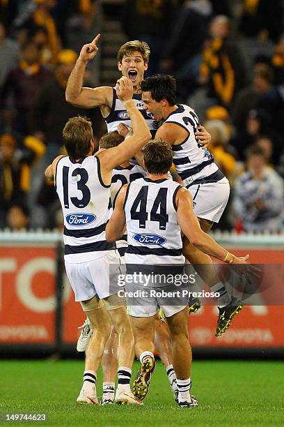 Tom Hawkins of the Cats celebrates kicking a goal with team-mates to win the game during the round 19 AFL match between the Hawthorn Hawks and the...