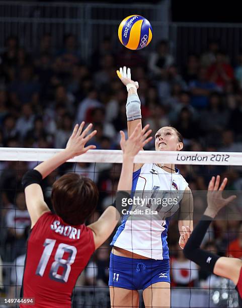 Ekaterina Gamova of Russia spikes the ball as Saori Kimura of Japan defends during Women's Volleyball on Day 7 of the London 2012 Olympic Games at...