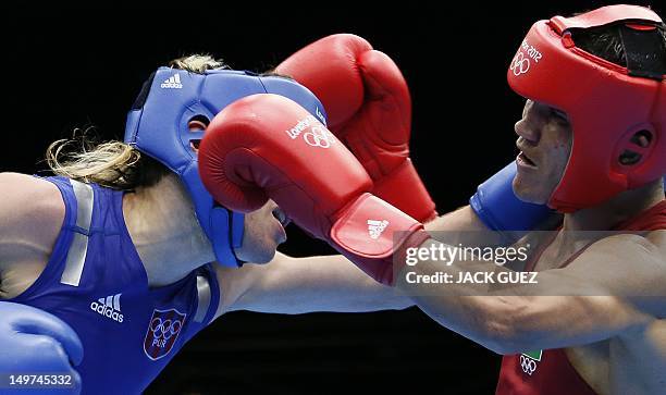 Juliao Henriques Neto of Brazil defends against Jeyvier Cintron Ocasio of Puerto Rico in their round of 16 Flyweight match of the London 2012 Olympic...