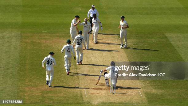 Nathan Lyon of Australia celebrates the wicket of Rohit Sharma of India during day four of the ICC World Test Championship Final between Australia...